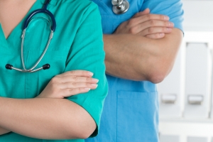 Two doctors standing with their arms crossed on chest ready to work.